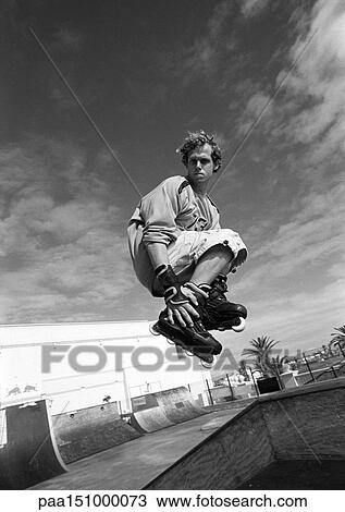 Young man on skateboard, jumping, mid-air. View Large Photo Image Stock Image - Young man on skateboard, jumping, mid-air.. Fotosearch