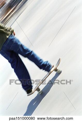 Young man on skateboard, low section. View Large Photo Image Stock Image - Young man on skateboard, low section.. Fotosearch