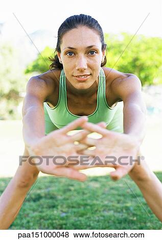 Young woman stretching, looking into camera, hands out toward camera, portrait. View Large Photo Image Stock Photo - Young woman stretching, looking into camera, hands out toward camera, portrait. . Fotosearch