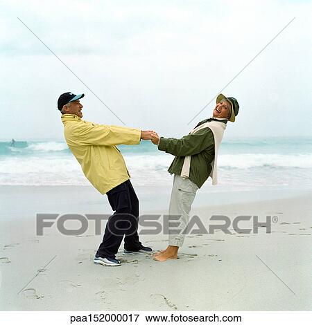 Mature couple holding hands on beach. View Large Photo Image Stock Photo - Mature couple holding hands on beach.. Fotosearch