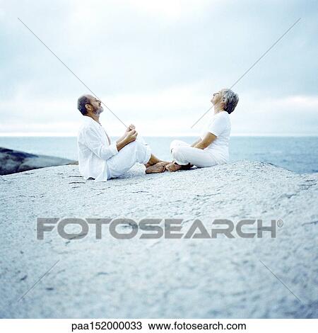 Mature couple sitting on rock, facing each other. View Large Photo Image Stock Image - Mature couple sitting on rock, facing each other.. Fotosearch