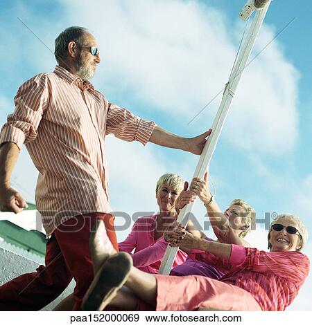 Mature group playing around pole View Large Photo Image Stock Photo - Mature group playing around pole. Fotosearch