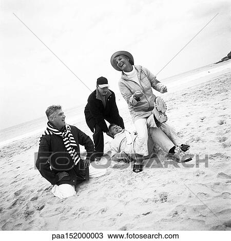 Mature group playing on beach, b&w. View Large Photo Image Stock Image - Mature group playing on beach, b&w.. Fotosearch