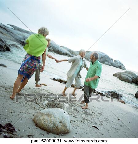 Mature group playing on beach. View Large Photo Image Stock Image - Mature group playing on beach.. Fotosearch