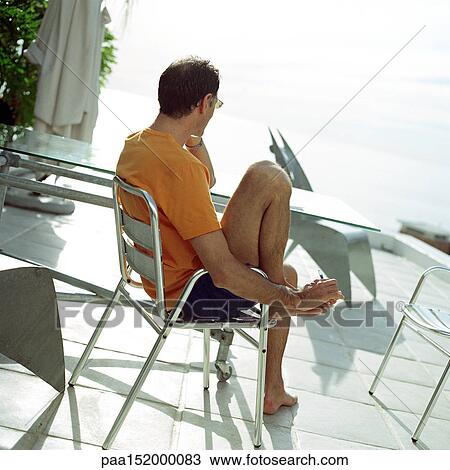 Mature man sitting, using phone, rear view. View Large Photo Image Stock Image - Mature man sitting, using phone, rear view.. Fotosearch