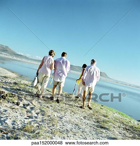 Two mature couples walking by the sea, rear view. View Large Photo Image Stock Photo - Two mature couples walking by the sea, rear view.. Fotosearch