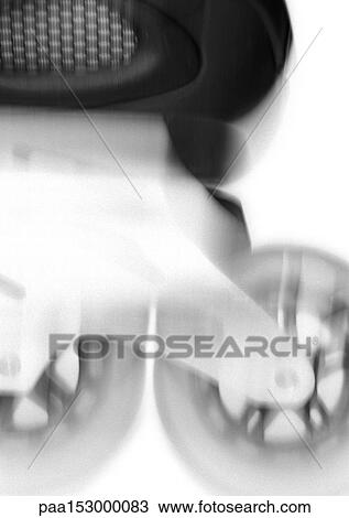 Stock Image - In-line skate, blurred, close-up of wheels, b&w.. Fotosearch