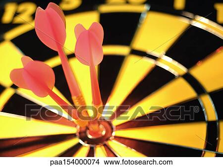 Darts in bullseye of dartboard, close-up. View Large Photo Image Picture - Darts in bullseye of dartboard, close-up.. Fotosearch
