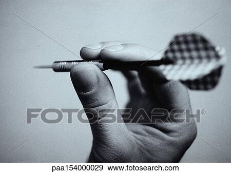 Hand holding dart, close-up, b&w. View Large Photo Image Stock Photo - Hand holding dart, close-up, b&w.. Fotosearch
