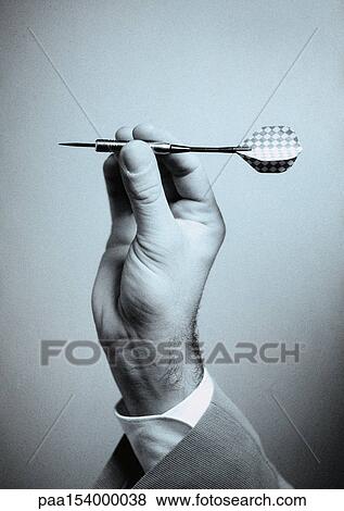 Hand holding dart, close-up, b&w. View Large Photo Image Stock Photo - Hand holding dart, close-up, b&w.. Fotosearch
