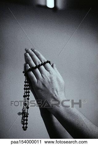 Hands holding rosary beads, b&w. View Large Photo Image Stock Image - Hands holding rosary beads, b&w.. Fotosearch