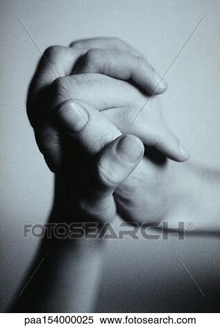 Stock Photography - Hands locked together, close-up, b&w.. Fotosearch