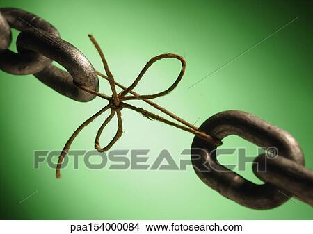 Two ends of a chain linked by string, close-up. View Large Photo Image Picture - Two ends of a chain linked by string, close-up.. Fotosearch