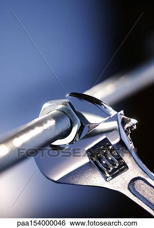 Wrench locked onto nut, close-up. View Large Photo Image Stock Photograph - Wrench locked onto nut, close-up.. Fotosearch