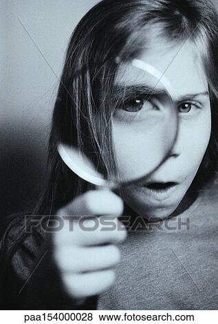 Young person looking into camera through magnifying glass, distorted view, portrait. View Large Photo Image Stock Photo - Young person looking into camera through magnifying glass, distorted view, portrait.. Fotosearch