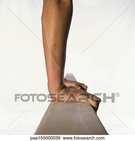 Female gymnast performing on balance beam, side view, close-up. View Large Photo Image Stock Photo - Female gymnast performing on balance beam, side view, close-up.. Fotosearch