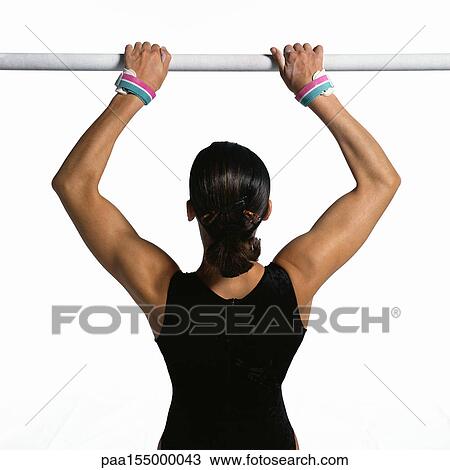 Female gymnast pulling herself up on horizontal bar, upper section, rear view. View Large Photo Image Stock Image - Female gymnast pulling herself up on horizontal bar, upper section, rear view.. Fotosearch