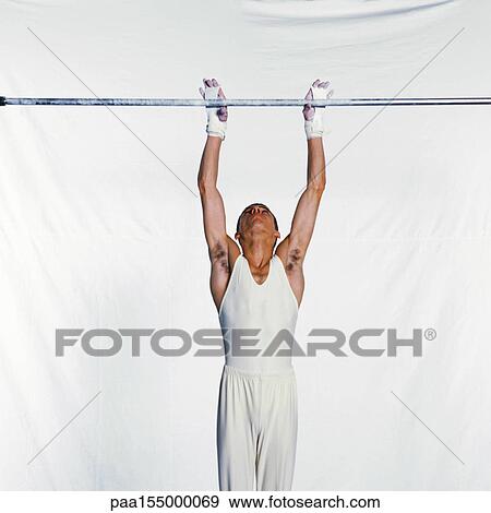 Male gymnast grasping horizontal bar. View Large Photo Image Stock Photo - Male gymnast grasping horizontal bar.. Fotosearch