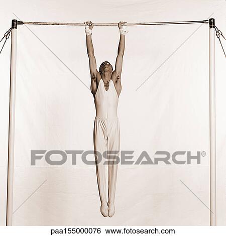 Male gymnast holding onto horizontal bar. View Large Photo Image Stock Photograph - Male gymnast holding onto horizontal bar.. Fotosearch