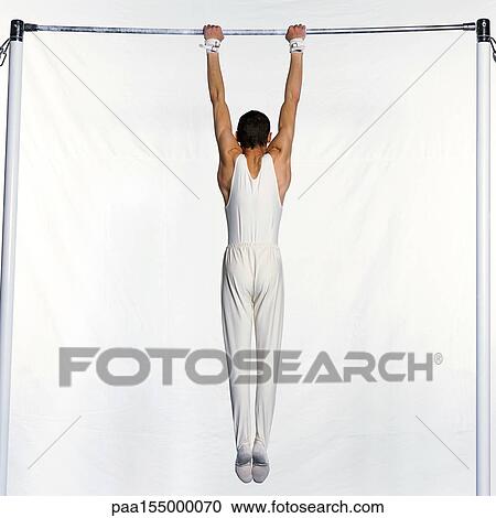 Male gymnast on horizontal bar, rear view. View Large Photo Image Stock Image - Male gymnast on horizontal bar, rear view.. Fotosearch