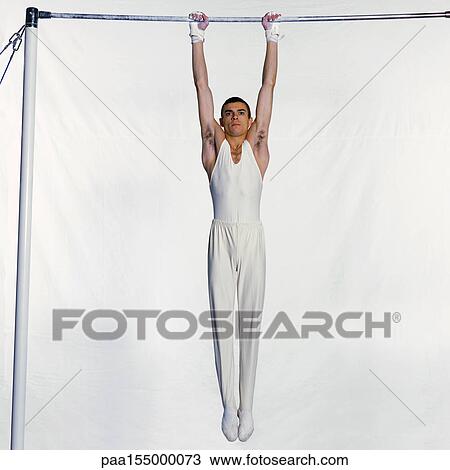 Male gymnast on horizontal bar. View Large Photo Image Stock Image - Male gymnast on horizontal bar.. Fotosearch