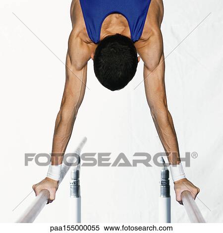 Male gymnast performing handstand on parallel bars, upper section, rear view. View Large Photo Image Stock Photography - Male gymnast performing handstand on parallel bars, upper section, rear view.. Fotosearch
