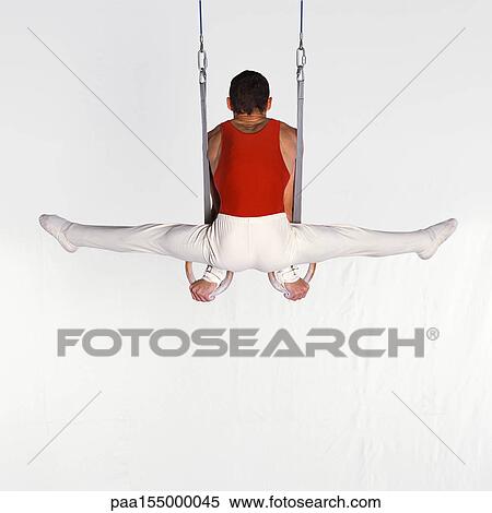 Male gymnast performing on rings, rear view. View Large Photo Image Stock Photography - Male gymnast performing on rings, rear view.. Fotosearch