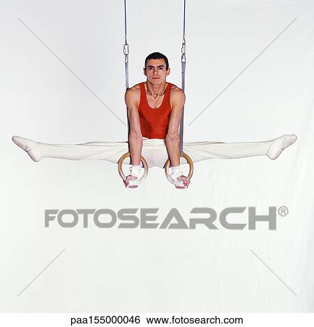 Male gymnast performing on rings. View Large Photo Image Stock Photograph - Male gymnast performing on rings.. Fotosearch