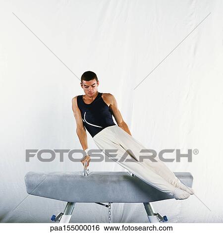 Male gymnast performing routine on pommel horse. View Large Photo Image Stock Photograph - Male gymnast performing routine on pommel horse. . Fotosearch