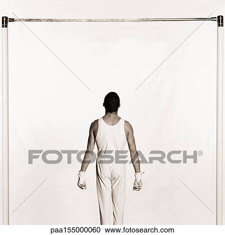 Male standing under horizontal bar, rear view, b&w. View Large Photo Image Stock Image - Male standing under horizontal bar, rear view, b&w.. Fotosearch