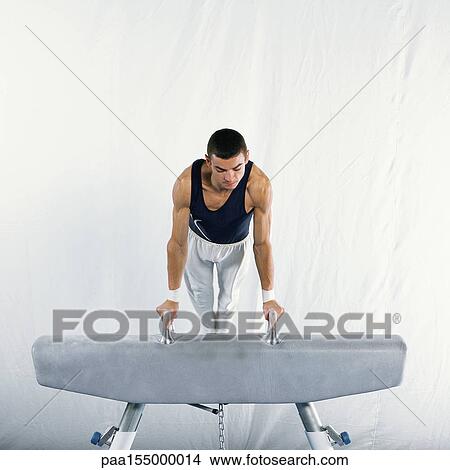 Young male gymnast mounting pommel horse. View Large Photo Image Picture - Young male gymnast mounting pommel horse.. Fotosearch