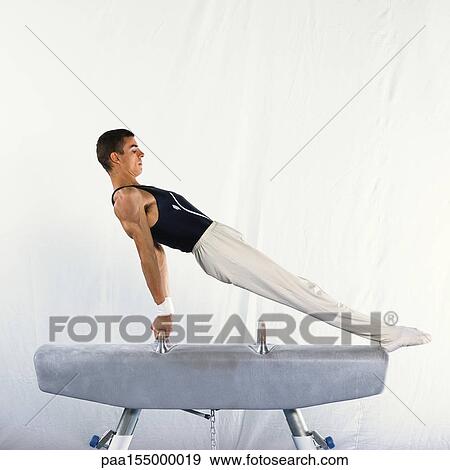 Young male performing routine on pommel horse, side view. View Large Photo Image Stock Photo - Young male performing routine on pommel horse, side view.. Fotosearch