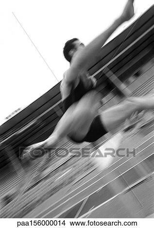 Athlete jumping hurdle, blurred motion, close-up, b&w View Large Photo Image Picture - Athlete jumping hurdle, blurred motion, close-up, b&w. Fotosearch