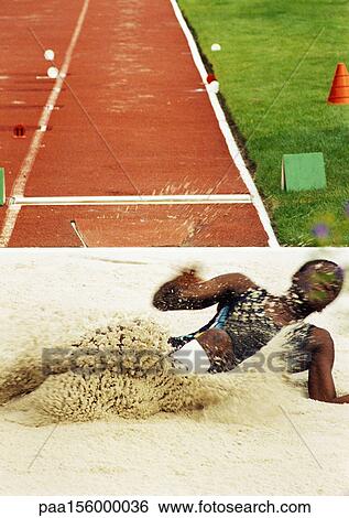 Female long jumper landing in sand pit View Large Photo Image Stock Photograph - Female long jumper landing in sand pit. Fotosearch
