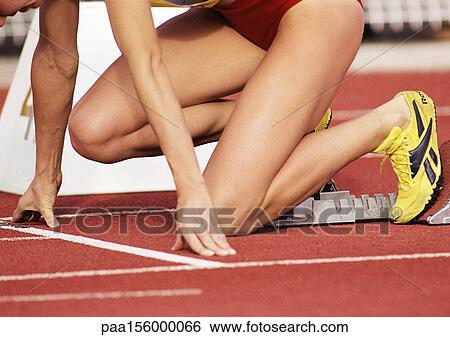 Female runner on starting block, low section, close-up View Large Photo Image Stock Photograph - Female runner on starting block, low section, close-up. Fotosearch