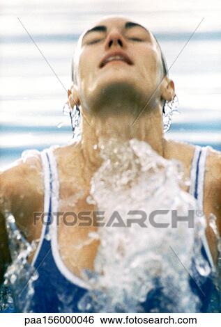 Female swimmer emerging from water, close-up View Large Photo Image Stock Photograph - Female swimmer emerging from water, close-up. Fotosearch