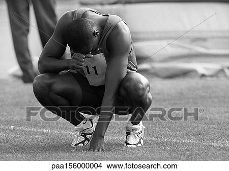 Male athlete crouching, head down, b&w View Large Photo Image Picture - Male athlete crouching, head down, b&w. Fotosearch