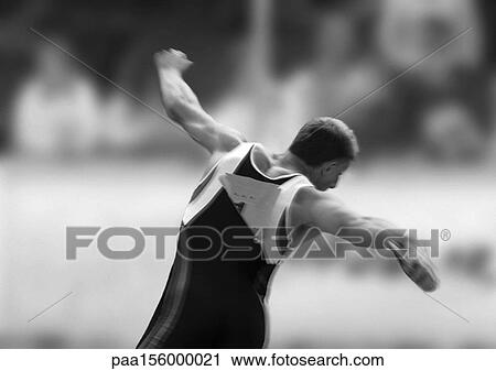 Male athlete throwing discus, rear view, b&w View Large Photo Image Stock Image - Male athlete throwing discus, rear view, b&w. Fotosearch