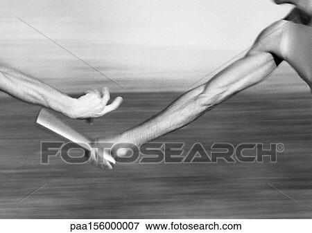 Male athletes passing relay baton, close-up, b&w View Large Photo Image Stock Photo - Male athletes passing relay baton, close-up, b&w. Fotosearch