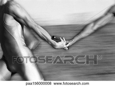Male athletes passing relay baton, close-up, b&w View Large Photo Image Stock Photo - Male athletes passing relay baton, close-up, b&w. Fotosearch