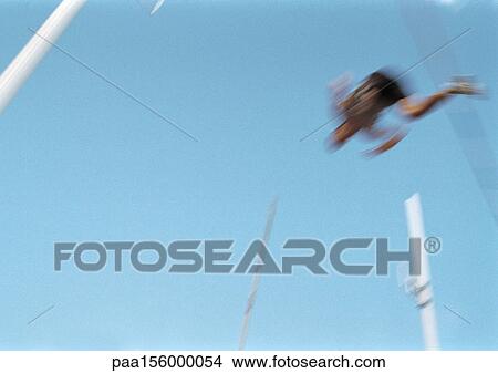 Male pole vaulter in mid-air, blurred motion View Large Photo Image Picture - Male pole vaulter in mid-air, blurred motion. Fotosearch