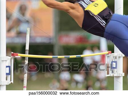 Male pole vaulter swinging over pole, rear view View Large Photo Image Stock Image - Male pole vaulter swinging over pole, rear view. Fotosearch