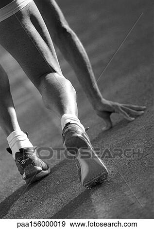 Male runner at start of race, rear view, b&w View Large Photo Image Stock Photo - Male runner at start of race, rear view, b&w. Fotosearch