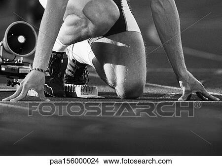 Male runner at starting block, low angle view, close-up, b&w View Large Photo Image Picture - Male runner at starting block, low angle view, close-up, b&w. Fotosearch