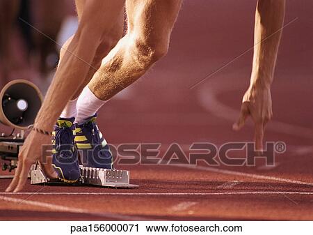 Male runner leaving starting block, low section, close-up View Large Photo Image Stock Image - Male runner leaving starting block, low section, close-up. Fotosearch