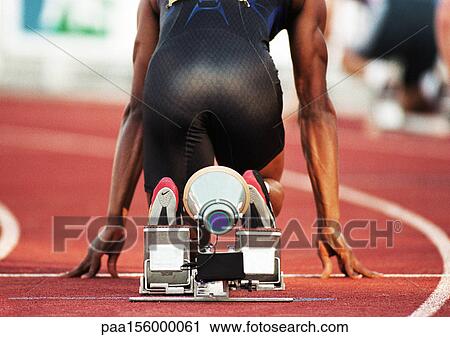 Male runner on starting block, rear view View Large Photo Image Stock Image - Male runner on starting block, rear view. Fotosearch