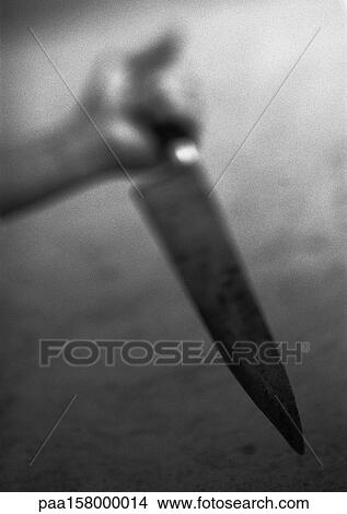Hand holding kitchen knife, blurred, b&w View Large Photo Image Picture - Hand holding kitchen knife, blurred, b&w. Fotosearch