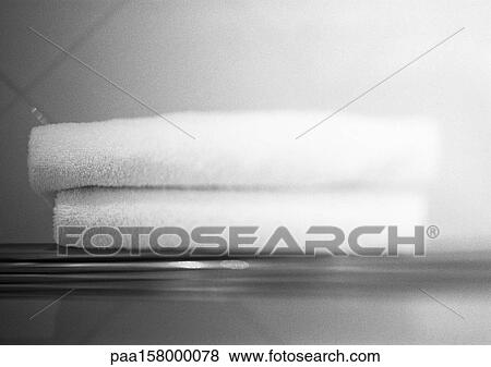 Two folded towels on shelf, blurred, b&w. View Large Photo Image Stock Photo - Two folded towels on shelf, blurred, b&w.. Fotosearch