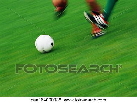 Feet of two soccer players running for ball, low section, blurred View Large Photo Image Stock Photography - Feet of two soccer players running for ball, low section, blurred. Fotosearch