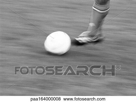 Foot of player and soccer ball, blurred, b&w. View Large Photo Image Stock Photo - Foot of player and soccer ball, blurred, b&w.. Fotosearch